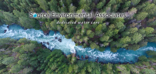 A crystal clear river flowing between lush banks of coniferous trees, with the title "Source Environmental Associates" and the subtitle "dedicated water care"